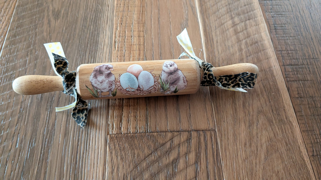 Silkie chickens on a rolling pin